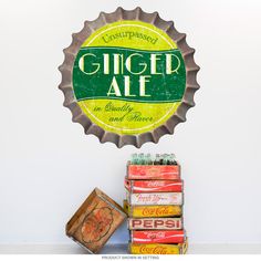 a beer bottle cap with the word ginger ale on it next to some old soda cans