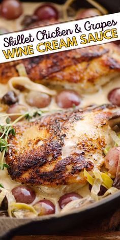 a pan filled with chicken and grapes on top of a wooden table