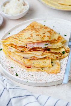 a white plate topped with quesadillas covered in cheese