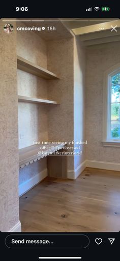 an empty room with some shelves and a window on the wall, in front of a wooden floor