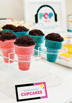 cupcakes with chocolate sprinkles are on display at a pop up store