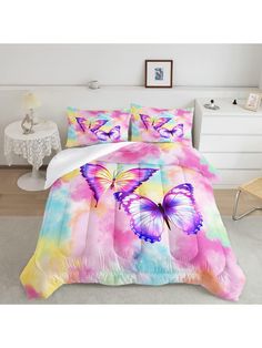 a bed with pink and blue butterflies on it