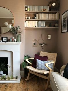 a living room with a fire place and bookshelf