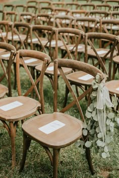 rows of wooden chairs set up for an outdoor ceremony