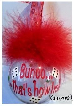 a glass ornament with a red fuzzy ball on it and the words bunco that's how