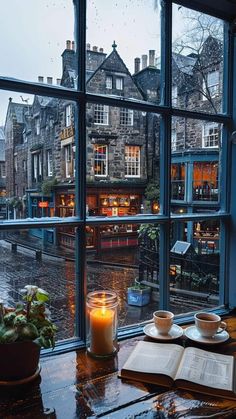 an open book sitting on top of a table next to a window