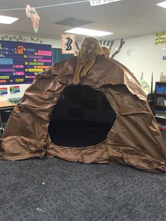 a tent made out of brown paper in an office cubicle