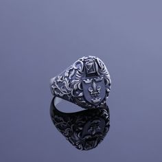 Family crests, also known as coat of arms, are heraldic symbols that represent a particular family or individual. These symbols often include elements such as shields, animals, colors, and other symbolic images. The family crest is usually passed down through generations and holds historical and familial significance. We have created a family crest ring for you that will be considered an heirloom and will be passed down from one generation to the next, serving as a symbol of heritage, tradition Luxury Vintage Signet Ring With Coat Of Arms, Classic Coat Of Arms Collectible Rings, Classic Coat Of Arms Collectible Jewelry, Classic Coat Of Arms Jewelry For Collectors, Medieval Engraved Signet Ring Gift, Medieval Engraved Signet Ring For Gift, Silver Engraved Ring With Coat Of Arms, Classic Collectible Signet Ring With Coat Of Arms, Classic Sterling Silver Jewelry With Coat Of Arms