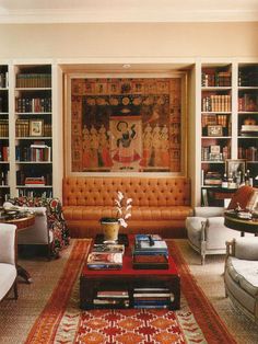 a living room filled with furniture and bookshelves