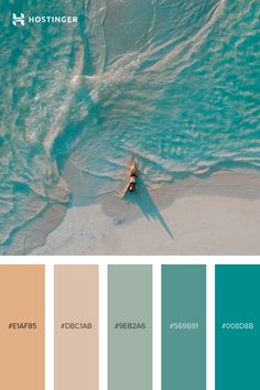 an aerial view of a person in a kayak on the beach with blue water