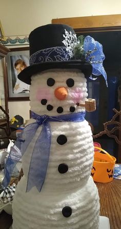 a snowman made out of toilet paper on top of a table