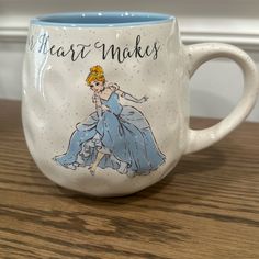 a coffee mug with a drawing of a princess on the side and words that read heart makes