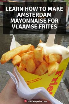 a hand holding a basket full of fries with the words learn how to make amsterdamam mayonnaise for vlamse frites