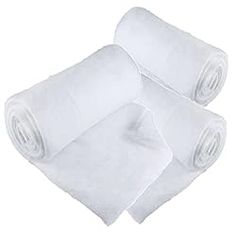 three rolls of white paper sitting on top of each other