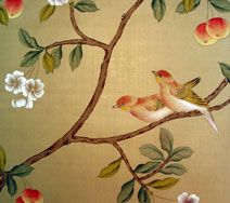 two birds sitting on a branch with flowers and leaves painted on the wall behind them