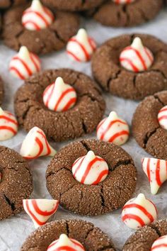 chocolate cookies with white and red candy canes on top