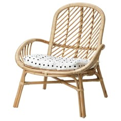 a wicker chair with polka dot cushions