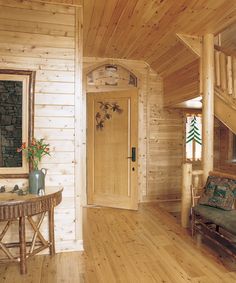 a living room with wooden walls and flooring