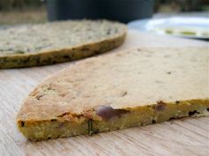 two pieces of food sitting on top of a wooden table