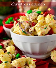 christmas crunch in a white bowl with candy canes and sprinkles on the side