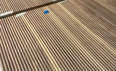 an aerial view of a street sign on the side of a building with corrugated roofing