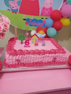 a pink birthday cake with pep the pig on top and balloons in the back ground