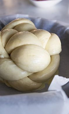 a bowl filled with white bread sitting on top of a table