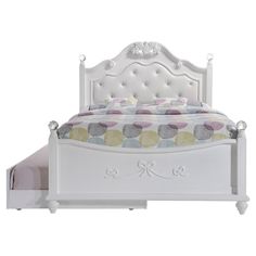 a white bed with an upholstered headboard and foot board