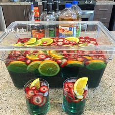 two glasses filled with liquid and sliced strawberries