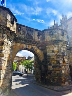 an old stone arch with a flag on it