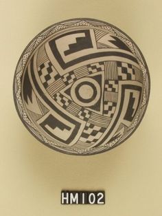 a black and white image of a bowl with geometric designs on it