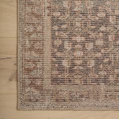 an area rug is shown on the floor with wooden floors and wood planks in the background