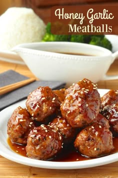 meatballs covered in sauce on a plate with chopsticks next to the bowl