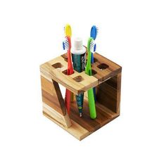 the toothbrush holder is made out of wood and holds several different colored toothbrushes