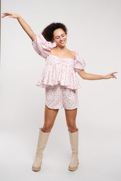 Embrace playful elegance with our Pink Pearly Floral Cotton Short Set by Madeline Marie, a perfect blend of comfort and style. This charming set features a pink floral print on a lightweight, breathable fabric, ideal for warm weather. The top boasts trendy puff sleeves and a flattering gathered bust, while the matching shorts offer an easy, relaxed fit with a comfortable elastic waistband. Versatile and stylish, this set is perfect for casual outings, lounging at home, or summer parties. Pair wi Dress Label, Slow Fashion Brands, Nyc Shopping, Glamorous Dresses, Favorite Boots, Pink Floral Print, Summer Parties, Short Set, Custom Dresses