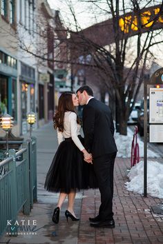 a man and woman kissing on the street