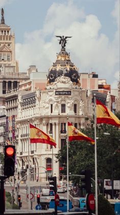 a city street with flags and buildings in the background