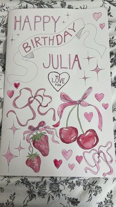 a birthday card for julia with hearts and cherries on the front, in pink ink