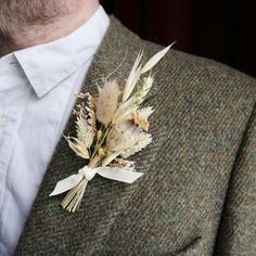 a man in a suit with a boutonniere on his lapel