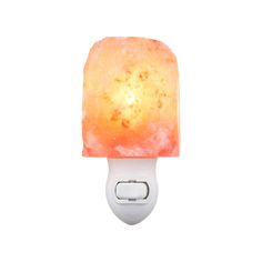 a light that is sitting on top of a white wall mounted device with a red and yellow himalayan stone in the middle