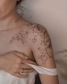 a woman with a flower tattoo on her chest