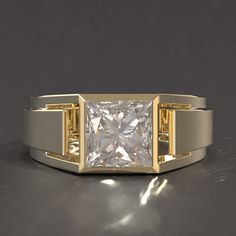 a gold and white ring with a princess cut diamond in the center on a gray surface