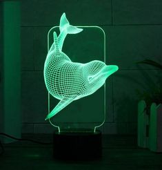 a 3d image of a dolphin is shown on a night stand with the light turned on