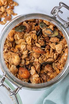 a glass bowl filled with granola and nuts