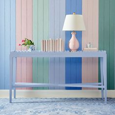 a blue table with books and a lamp on it