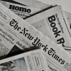 newspapers are stacked on top of each other in this black and white photo, with the newspaper's front pages torn off