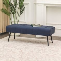 a blue bench sitting on top of a white rug