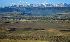 an open field with mountains in the background