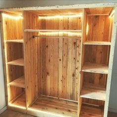 an empty wooden closet with shelves and lights