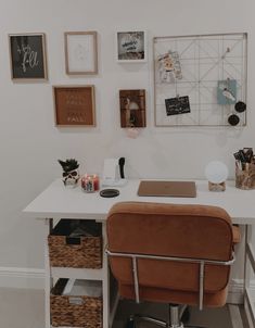 a white desk topped with a brown chair and lots of pictures on the wall behind it